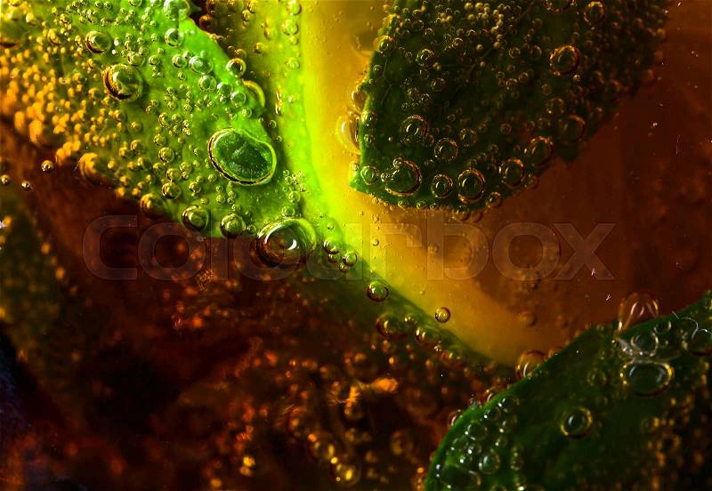 Cola with lime , ice and peppermint , macro shot, stock photo