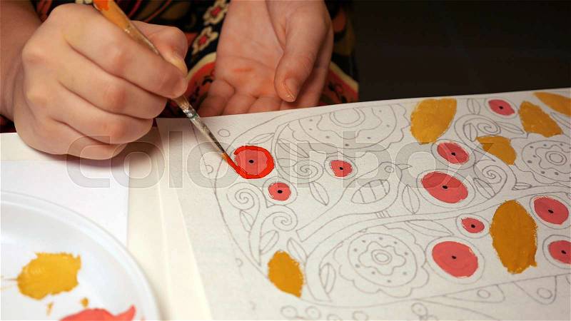 Preschooler kid child learns to draw and paint a watercolor picture with paintbrush, stock photo