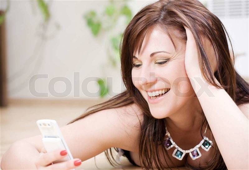 Portrait of happy woman with white phone, stock photo