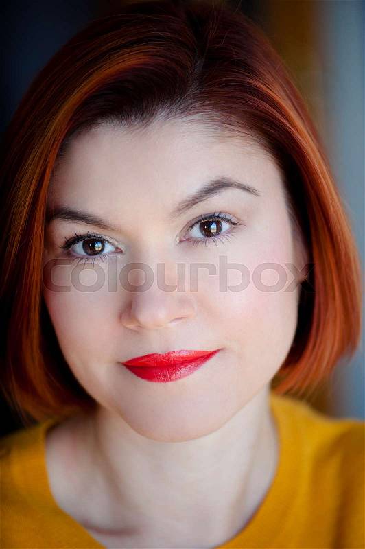 Redhead beautiful woman smiling with a professional make-up, stock photo