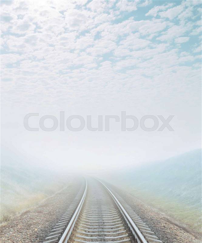 Railroad goes to foggy horizon, stock photo