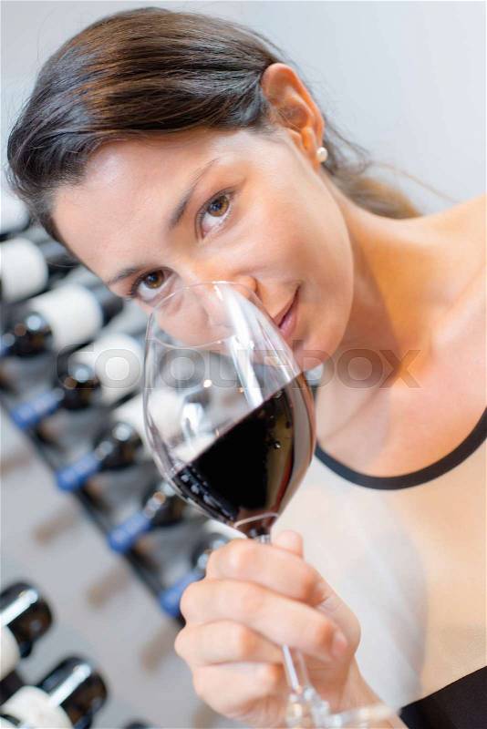 Woman smelling wine bouquet, stock photo