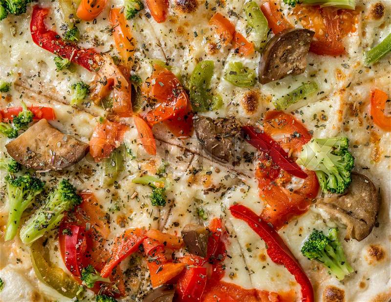 Hot steaming pizza with vegetables and mushrooms, cheese, served and cut, closeup, topview, stock photo