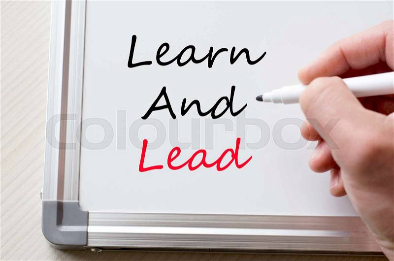 Human hand writing learn and lead on whiteboard, stock photo