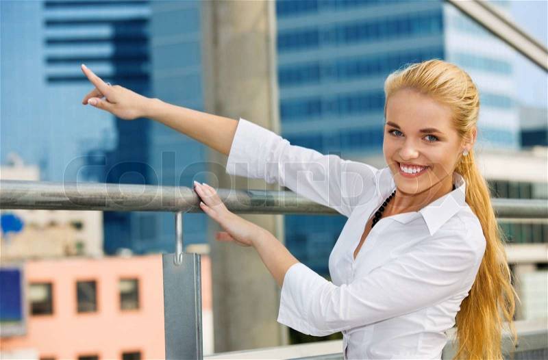 Happy businesswoman in a front of building site, stock photo