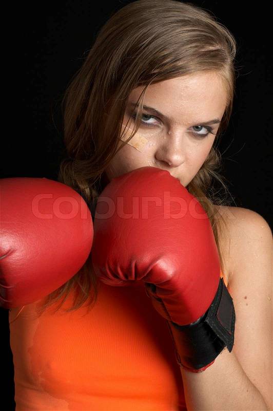 Boxing girl in orange shirt, stock photo