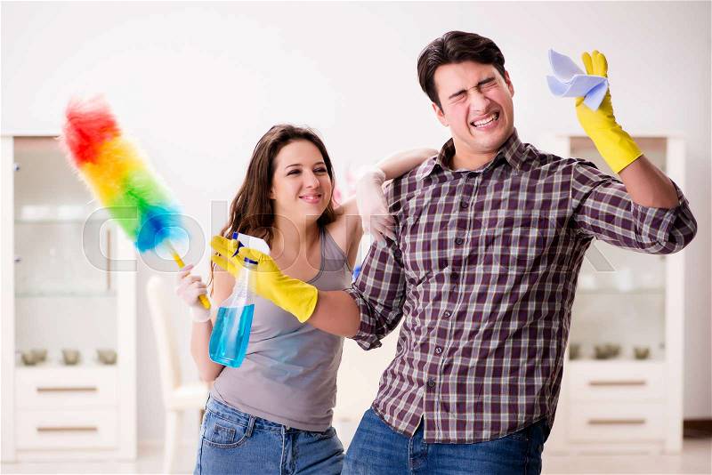 Wife and husband doing cleaning at home, stock photo