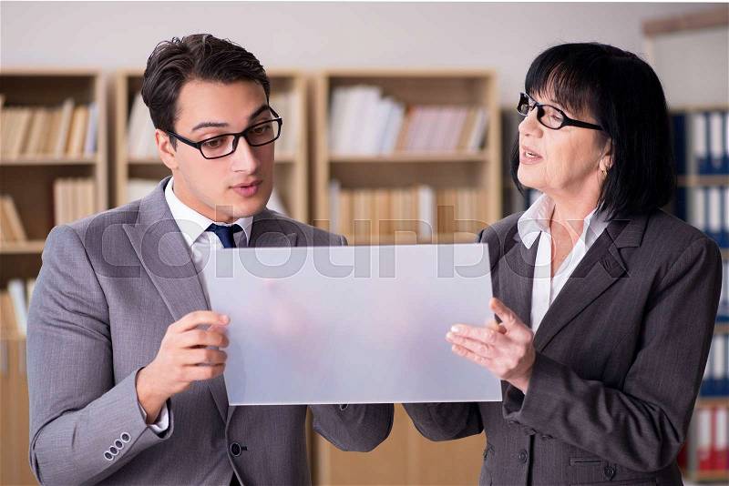 Business couple discussing business results on tablet, stock photo
