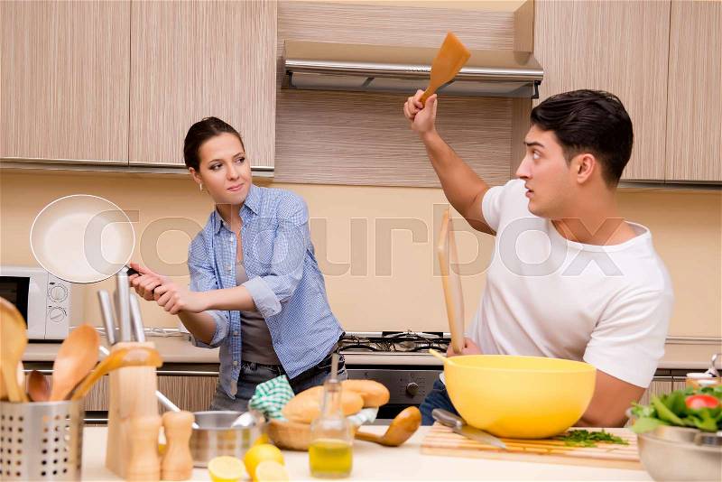 Young family doing funny fight at kitchen, stock photo