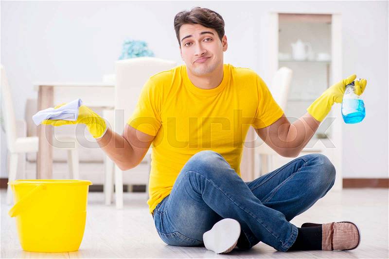 Man husband cleaning the house helping his wife, stock photo