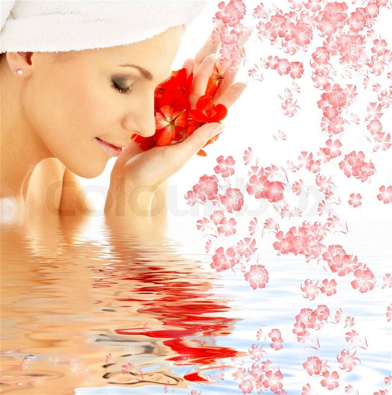 Lovely woman with red flower petals in water, stock photo