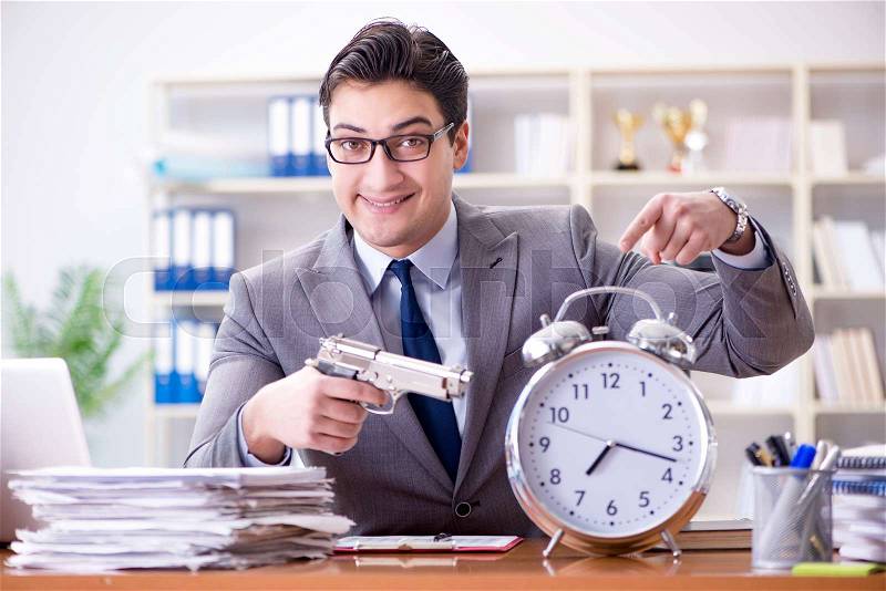 Young businessman in time management concept, stock photo