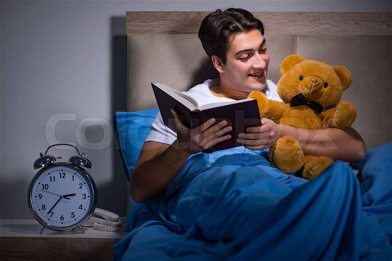 Young man sleeping in the bed, stock photo