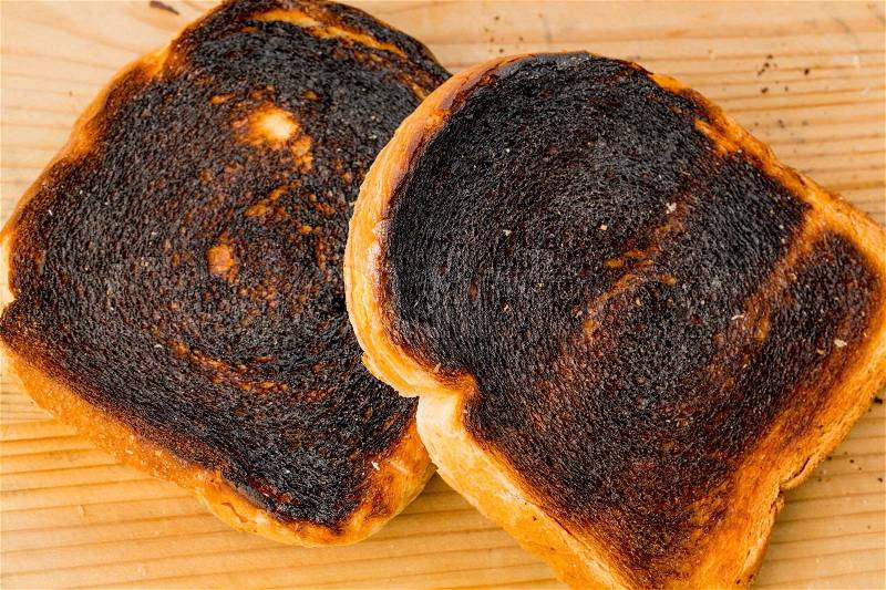 Toast was burned during toasting. burnt toast at breakfast, stock photo