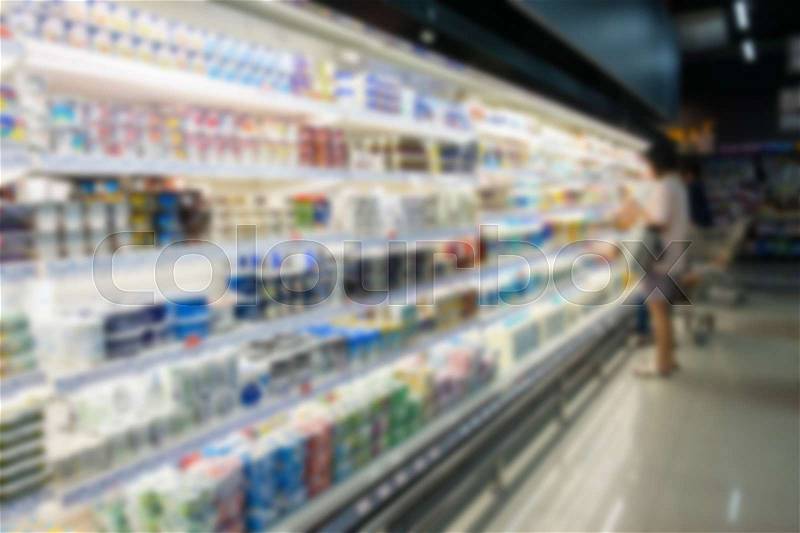 Defocused blur of supermarket shelves with dairy products. Blur background, stock photo