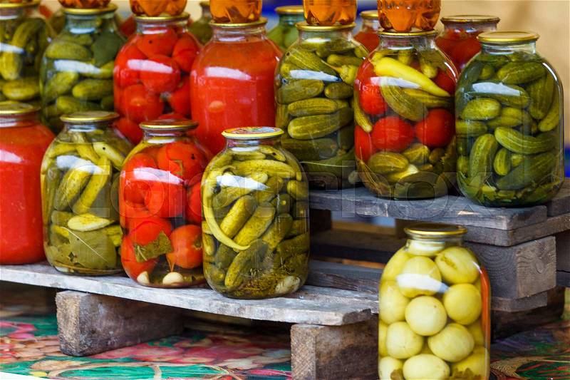 Jars with pickled vegetables. Preserved vegetables. tomatoes and cucumbers. preserved tomatoes and cucumbers at market, stock photo