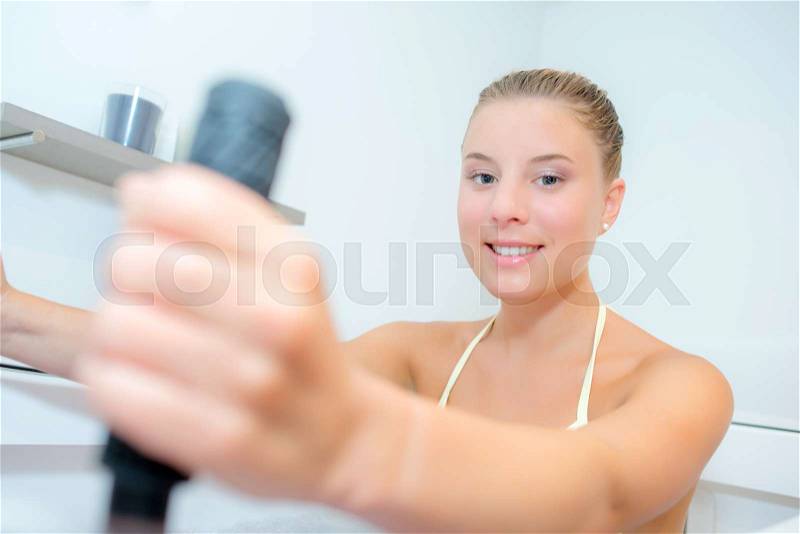 Lady exercising in water bath, stock photo