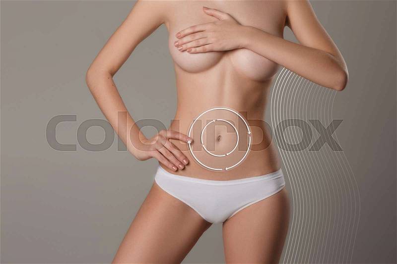 Women belly with the drawing arrows. The cellulite removal plan. White markings on young woman body preparing for plastic surgery. Concept of slimming, liposuction, strand lifting, stock photo