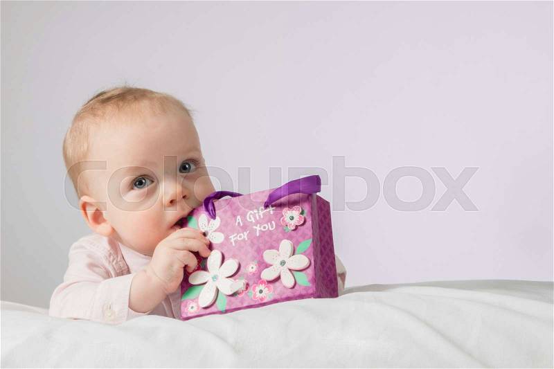 Mothers day. Adorable infant boy with a gift. Postcard for mothers day or any holiday, stock photo