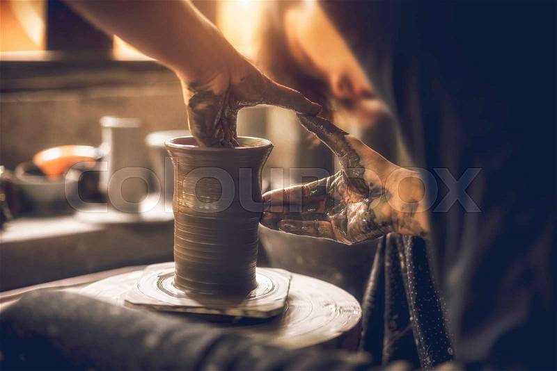 Craftsman artist making craft, pottery, sculptor from fresh wet clay on pottery wheel, selected focus, stock photo
