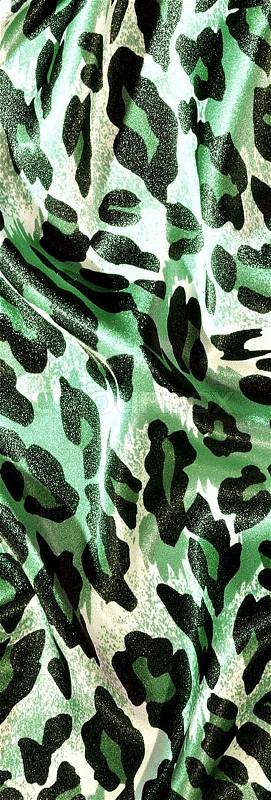Silk leopard print fabric close up background, stock photo