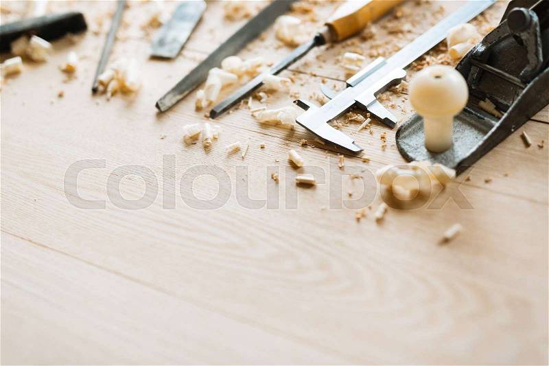 Still life of carpentry tools on wooden table background, shaving scattered everywhere, close-up shot, stock photo