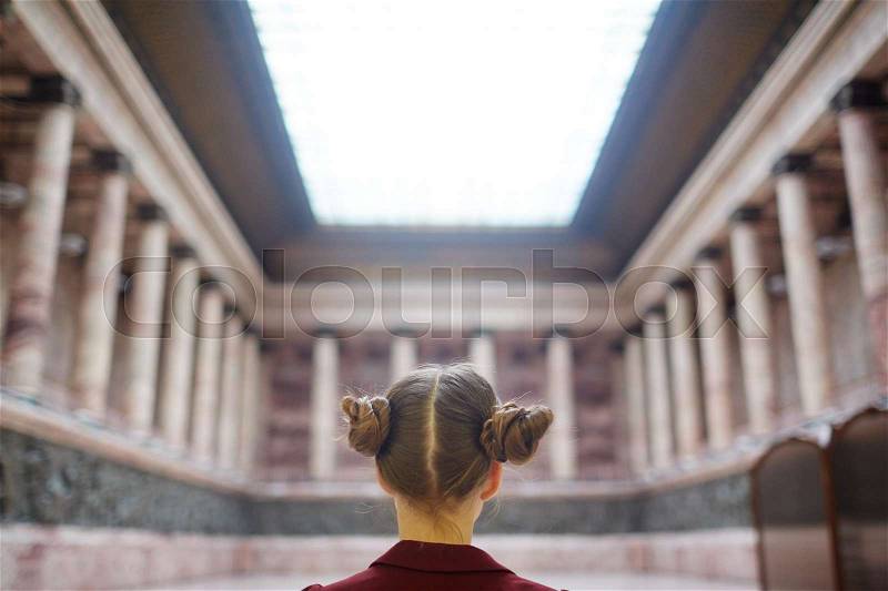 Back of head view of schoolgirl in museum, stock photo