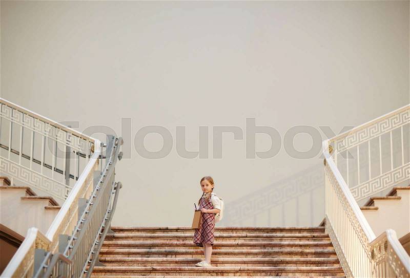 Little girl on marble staircase inside museum, stock photo