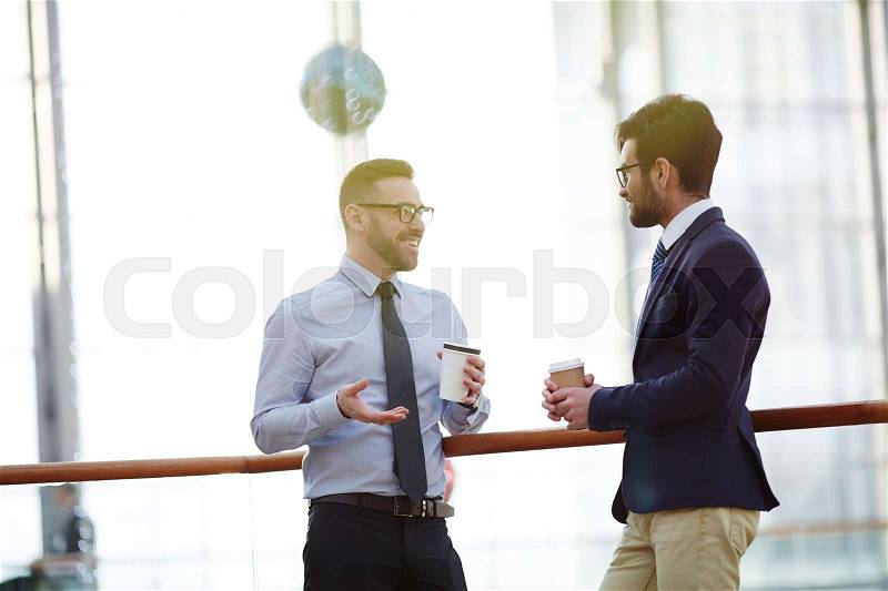 Conversation of successful bankers or co-workers at coffee-break, stock photo