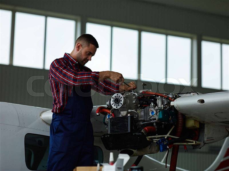 Modern engineer carrying out fixing work, stock photo
