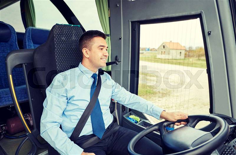 Transport, tourism, road trip and people concept - happy driver talking to microphone and driving bus, stock photo