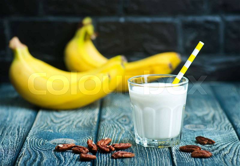 Banana yogurt with nuts in the glass, stock photo