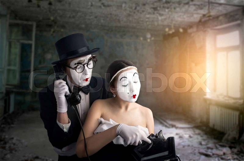 Pantomime theater actor and actress performing. Mime artists with white makeup masks on faces, stock photo