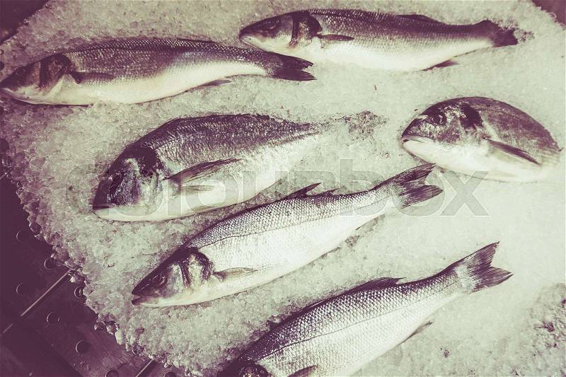 Fresh fish on ice. Vintage Retro Filter, stock photo