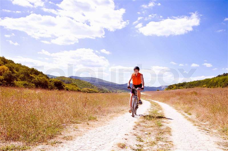 Young sportive man with his black muontain-bike, stock photo
