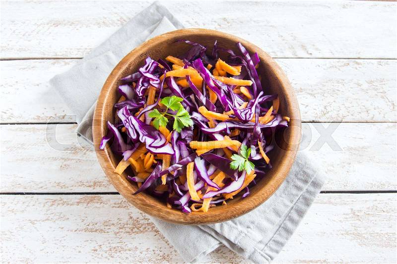 Red Cabbage Coleslaw Salad with Carrots and Greens - healthy diet, detox, vegan, vegetarian, vegetable spring salad, copy space for text, stock photo