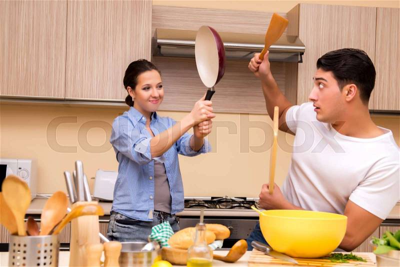 Young family doing funny fight at kitchen, stock photo