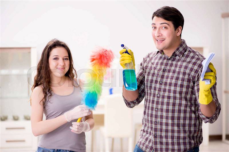 Wife and husband doing cleaning at home, stock photo