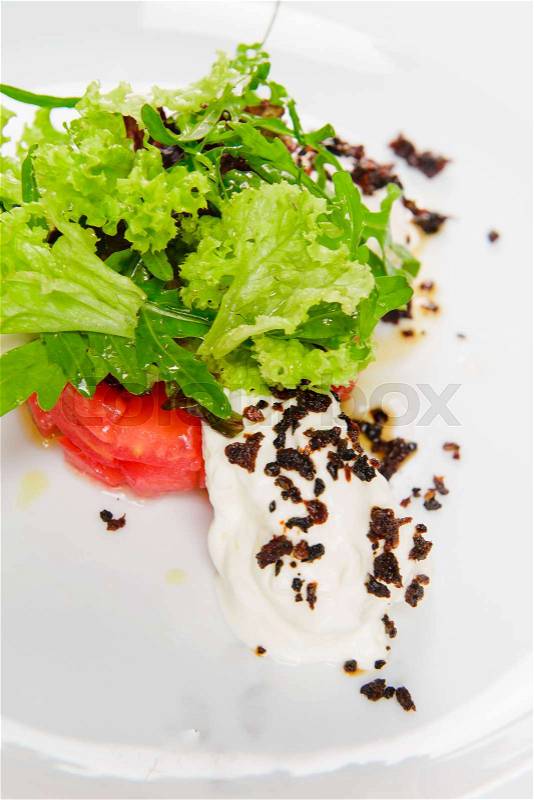 Vegetable salad with white sauce and grilled crumbs. Close-up, white background, stock photo