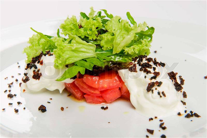 Vegetable salad with white sauce and grilled crumbs. Close-up, white background, stock photo