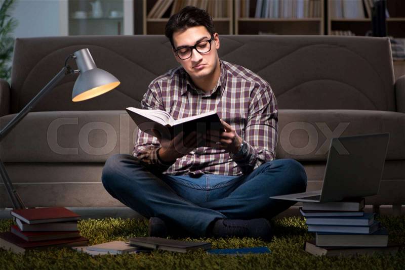 Student reading books preparing for exams, stock photo