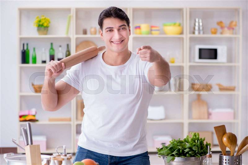 Young male cook working in the kitchen, stock photo