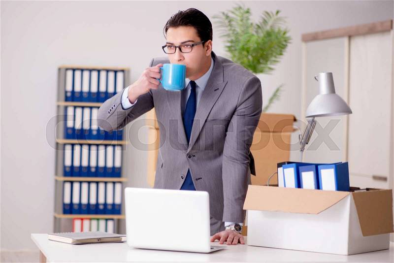 Businessman moving offices after promotion, stock photo