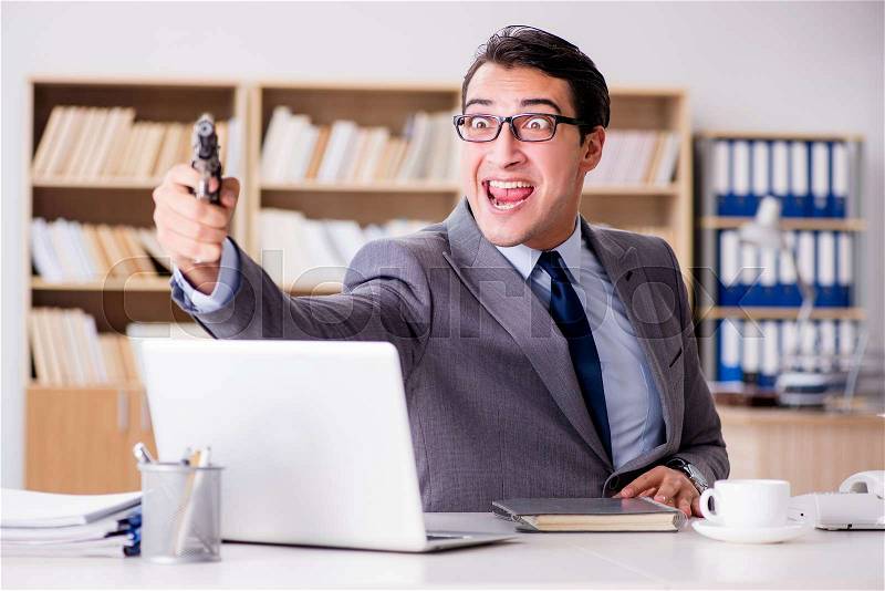 Funny businessman with gun in office, stock photo