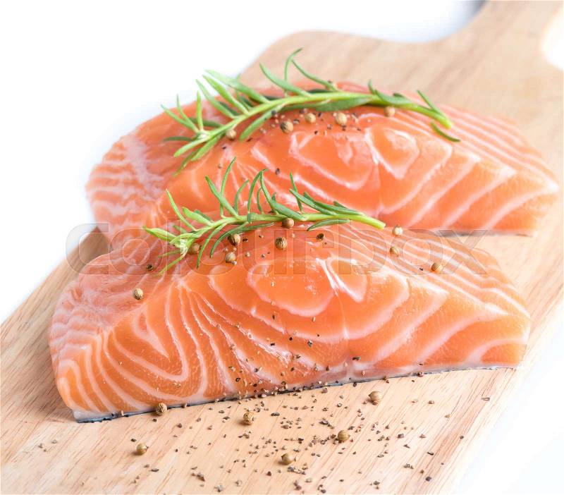 Sliced raw salmon on cutting board,white background, stock photo