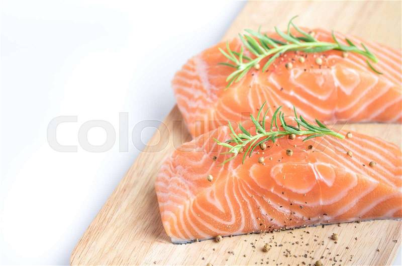 Sliced raw salmon on cutting board,white background, stock photo