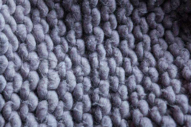 Merino wool handmade knitted large blanket, super chunky yarn, trendy concept. Close-up of knitted blanket, merino wool background, stock photo