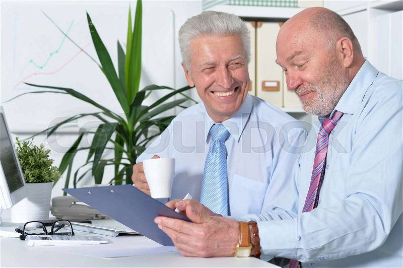 Two business people working together at a meeting, stock photo