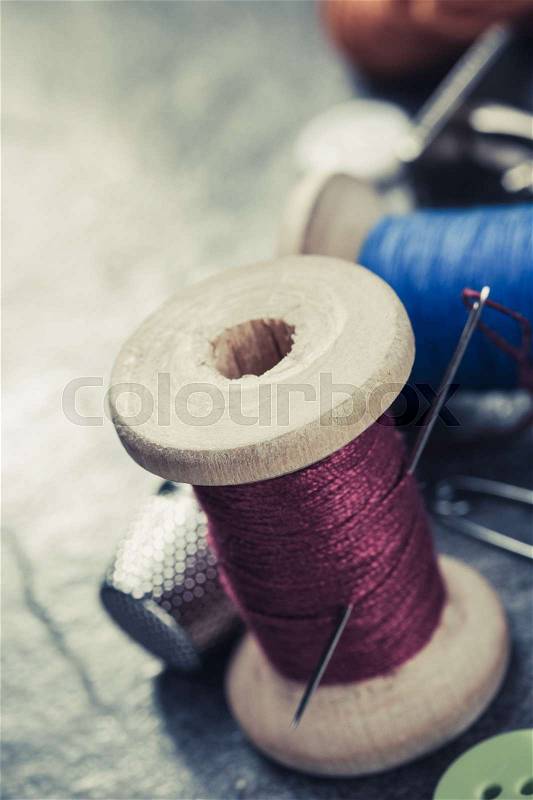 Sewing tools and accessories on table background, stock photo