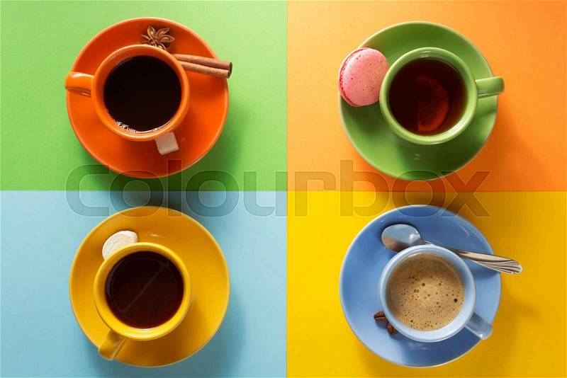 Cup of coffee, tea and cacao at colorful paper background, stock photo
